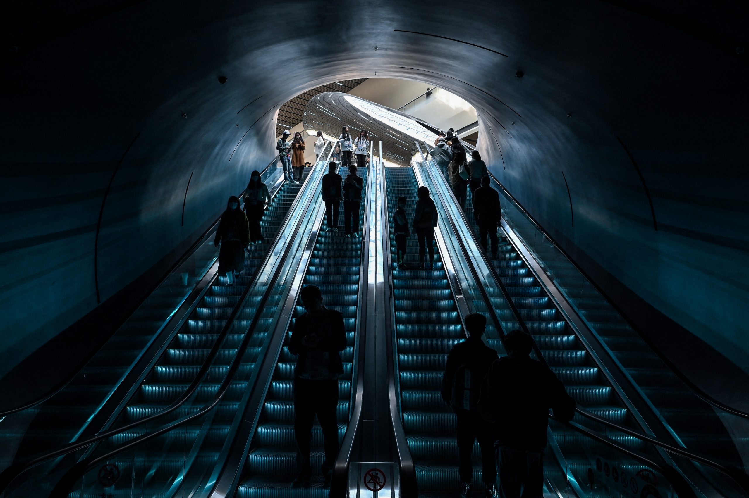 Visitors are seen on a scalator in the access to the 2023 World Science Fiction Convention in Chengdu, in Chinas southwest Sichuan province on October 21, 2023. (Photo by Hector RETAMAL / AFP)